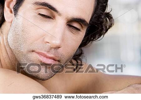 Close-up of a mid adult man with his eyes closed View Large Photo Image Stock Photo - Close-up of a mid adult man with his eyes closed. Fotosearch