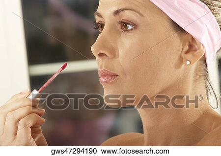 Close-up of a mid adult woman holding a lip liner View Large Photo Image Stock Image - Close-up of a mid adult woman holding a lip liner. Fotosearch