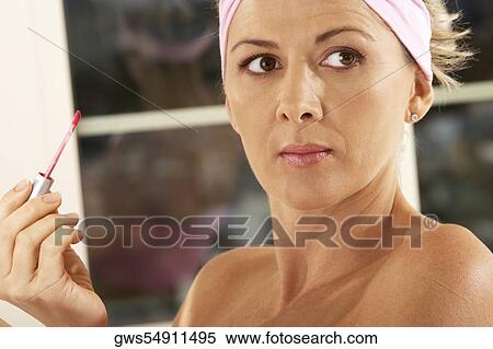 Close-up of a mid adult woman holding a lip liner View Large Photo Image Stock Photography - Close-up of a mid adult woman holding a lip liner. Fotosearch