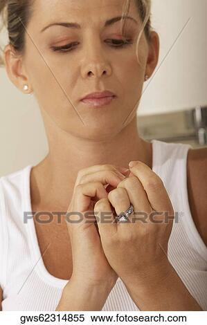 Close-up of a mid adult woman looking at her fingernails View Large Photo Image Stock Photography - Close-up of a mid adult woman looking at her fingernails. Fotosearch