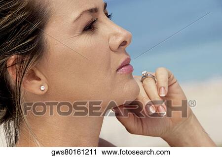 Close-up of a mid adult woman thinking View Large Photo Image Stock Image - Close-up of a mid adult woman thinking. Fotosearch