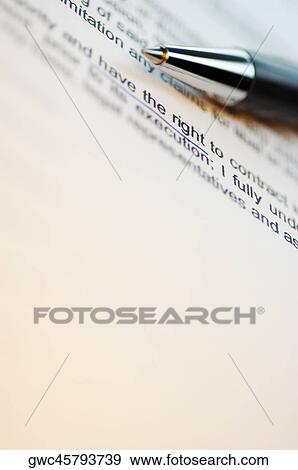 Stock Photo - Close-up of a pen on a printed document. Fotosearch