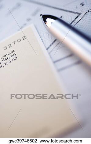 Stock Image - Close-up of a pen with banking documents. Fotosearch
