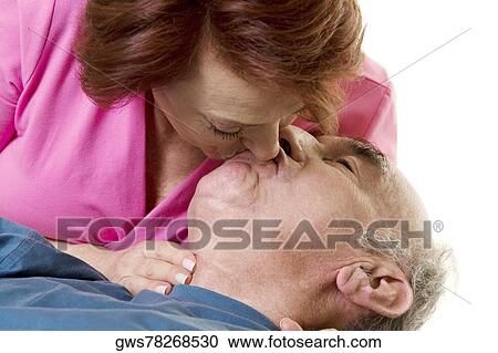 Close-up of a senior couple kissing View Large Photo Image Stock Image - Close-up of a senior couple kissing. Fotosearch