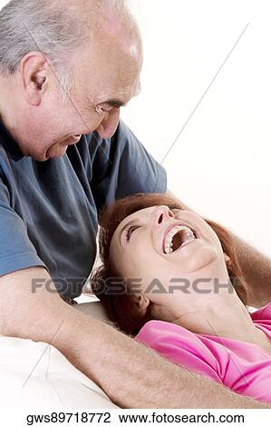 Close-up of a senior couple laughing and looking at each other View Large Photo Image Stock Image - Close-up of a senior couple laughing and looking at each other. Fotosearch
