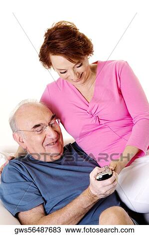 Close-up of a senior couple looking at a remote control View Large Photo Image Stock Image - Close-up of a senior couple looking at a remote control. Fotosearch