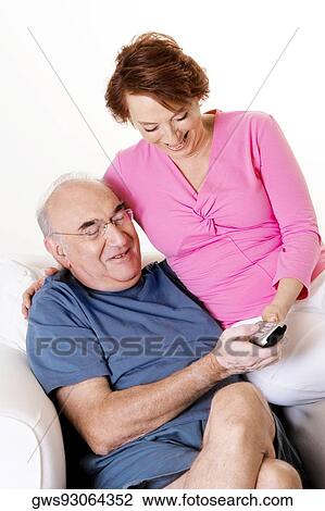 Close-up of a senior couple looking at a remote control View Large Photo Image Stock Image - Close-up of a senior couple looking at a remote control. Fotosearch