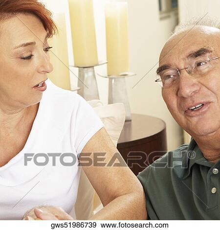 Close-up of a senior couple talking to each other View Large Photo Image Stock Photo - Close-up of a senior couple talking to each other. Fotosearch