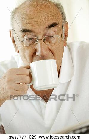 Close-up of a senior man drinking a cup of a coffee View Large Photo Image Stock Photo - Close-up of a senior man drinking a cup of a coffee. Fotosearch