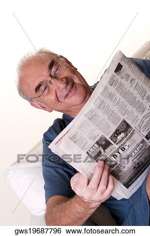 Stock Photograph - Close-up of a senior man reading a newspaper. Fotosearch