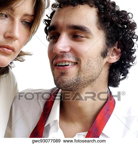Close-up of a serious young woman and a young man smiling View Large Photo Image Stock Photo - Close-up of a serious young woman and a young man smiling. Fotosearch
