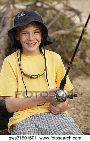 Close-up of a teenage boy holding a fishing rod View Large Photo Image Stock Image - Close-up of a teenage boy holding a fishing rod. Fotosearch