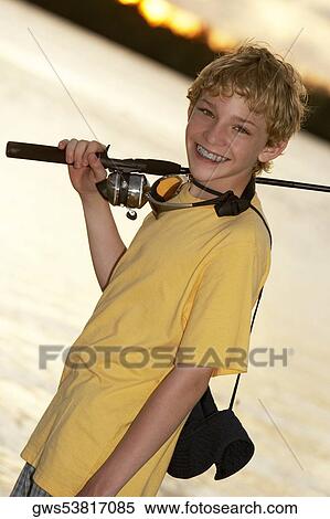 Close-up of a teenage boy holding a fishing rod View Large Photo Image Stock Photography - Close-up of a teenage boy holding a fishing rod. Fotosearch