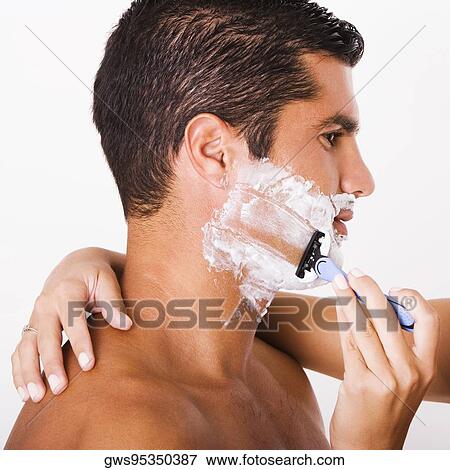 Close-up of a woman's hand shaving a mid adult man View Large Photo Image Stock Photo - Close-up of a woman's hand shaving a mid adult man. Fotosearch