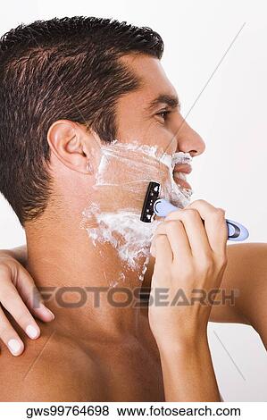 Close-up of a woman's hand shaving a mid adult man View Large Photo Image Stock Photo - Close-up of a woman's hand shaving a mid adult man. Fotosearch