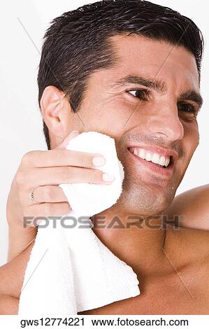 Close-up of a woman's hand wiping a mid adult man's face with a towel View Large Photo Image Stock Image - Close-up of a woman's hand wiping a mid adult man's face with a towel. Fotosearch
