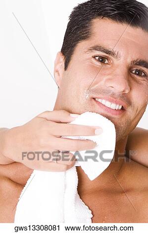 Close-up of a woman's hand wiping a mid adult man's face with a towel View Large Photo Image Stock Image - Close-up of a woman's hand wiping a mid adult man's face with a towel. Fotosearch