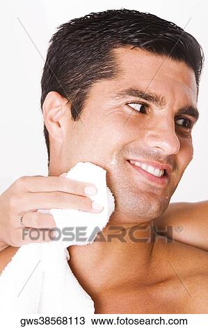 Close-up of a woman's hand wiping a mid adult man's face with a towel View Large Photo Image Stock Image - Close-up of a woman's hand wiping a mid adult man's face with a towel. Fotosearch