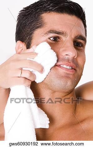 Close-up of a woman's hand wiping a mid adult man's face with a towel View Large Photo Image Stock Image - Close-up of a woman's hand wiping a mid adult man's face with a towel. Fotosearch