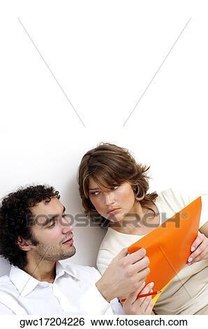 Close-up of a young couple discussing documents View Large Photo Image Stock Photograph - Close-up of a young couple discussing documents. Fotosearch