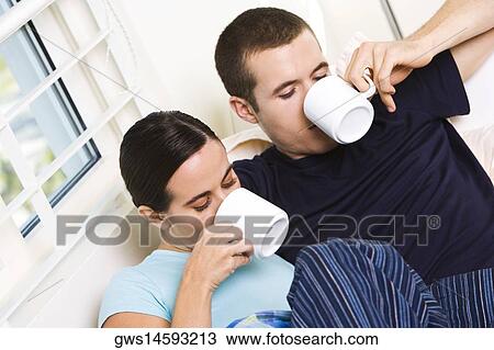 Stock Image - Close-up of a young couple drinking coffee. Fotosearch