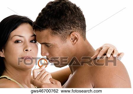 Close-up of a young couple holding a condom View Large Photo Image Stock Image - Close-up of a young couple holding a condom. Fotosearch