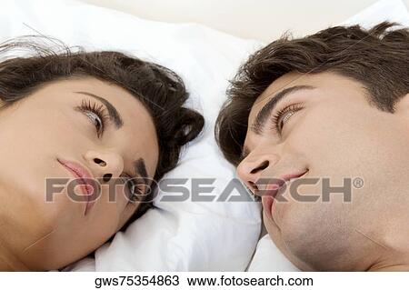 Close-up of a young couple looking at each other View Large Photo Image Stock Image - Close-up of a young couple looking at each other. Fotosearch