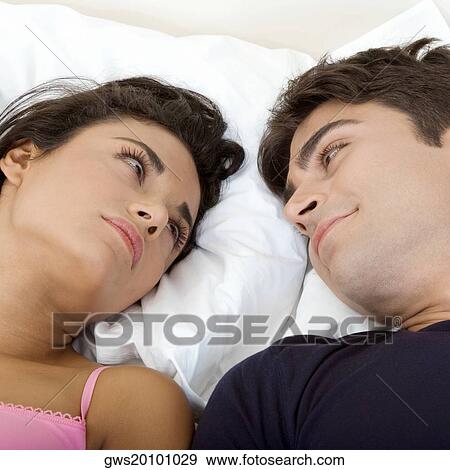 Close-up of a young couple looking at each other View Large Photo Image Stock Photo - Close-up of a young couple looking at each other. Fotosearch