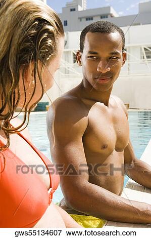 Stock Photo - Close-up of a young couple looking at each other. Fotosearch