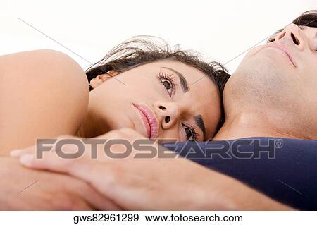 Close-up of a young couple lying on the bed View Large Photo Image Stock Photo - Close-up of a young couple lying on the bed. Fotosearch