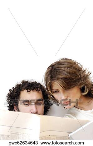 Close-up of a young couple reading a newspaper View Large Photo Image Stock Image - Close-up of a young couple reading a newspaper. Fotosearch