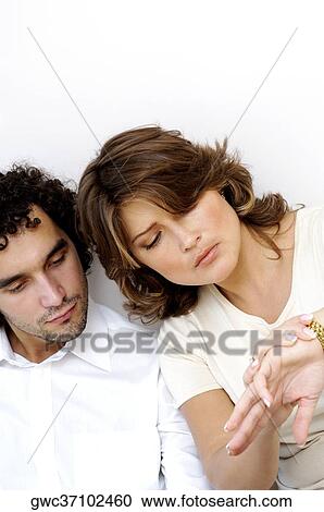 Stock Image - Close-up of a young couple sitting together. Fotosearch