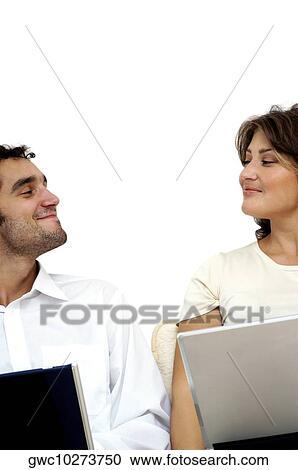 Close-up of a young couple sitting with laptops View Large Photo Image Stock Image - Close-up of a young couple sitting with laptops. Fotosearch