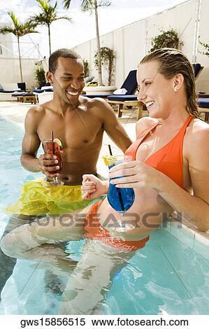 Close-up of a young couple smiling in a swimming pool View Large Photo Image Stock Photography - Close-up of a young couple smiling in a swimming pool. Fotosearch
