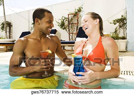 Close-up of a young couple smiling in a swimming pool View Large Photo Image Stock Photography - Close-up of a young couple smiling in a swimming pool. Fotosearch