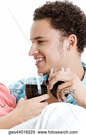 Close-up of a young couple toasting wine View Large Photo Image Stock Photography - Close-up of a young couple toasting wine. Fotosearch