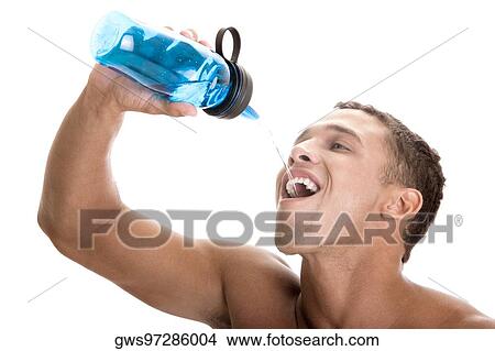 Close-up of a young man drinking water from a bottle View Large Photo Image Picture - Close-up of a young man drinking water from a bottle. Fotosearch