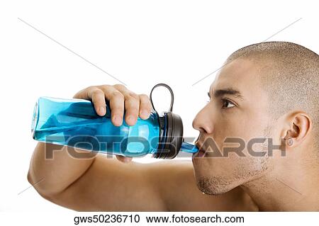 Close-up of a young man drinking water from a bottle View Large Photo Image Stock Image - Close-up of a young man drinking water from a bottle. Fotosearch