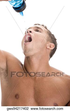Close-up of a young man drinking water from a bottle View Large Photo Image Stock Image - Close-up of a young man drinking water from a bottle. Fotosearch