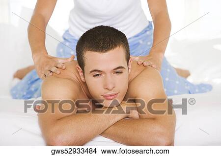 Close-up of a young man getting a shoulder massage View Large Photo Image Picture - Close-up of a young man getting a shoulder massage. Fotosearch