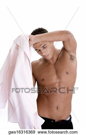 Stock Photo - Close-up of a young man getting dressed. Fotosearch