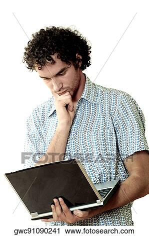 Close-up of a young man holding a laptop View Large Photo Image Stock Image - Close-up of a young man holding a laptop. Fotosearch