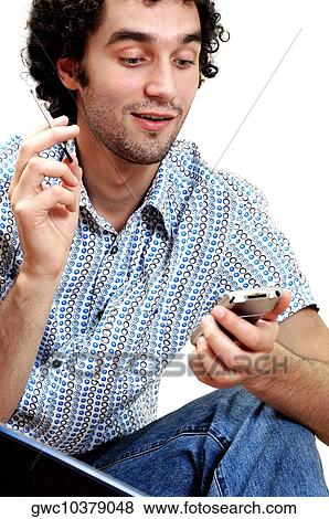 Stock Photo - Close-up of a young man holding a personal data assistant. Fotosearch
