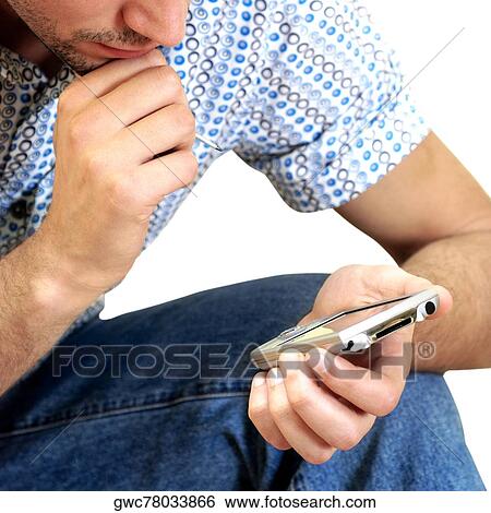 Stock Photograph - Close-up of a young man holding a personal data assistant. Fotosearch