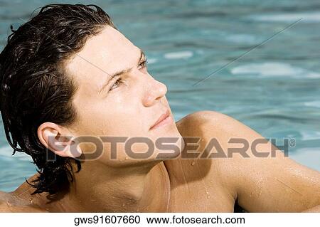 Close-up of a young man in a swimming pool View Large Photo Image Stock Image - Close-up of a young man in a swimming pool. Fotosearch