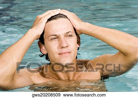 Close-up of a young man in a swimming pool View Large Photo Image Stock Photo - Close-up of a young man in a swimming pool. Fotosearch