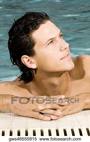 Close-up of a young man in a swimming pool View Large Photo Image Stock Photography - Close-up of a young man in a swimming pool. Fotosearch