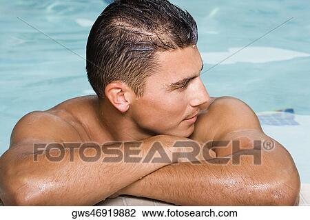 Close-up of a young man leaning at the edge of a swimming pool View Large Photo Image Stock Image - Close-up of a young man leaning at the edge of a swimming pool. Fotosearch