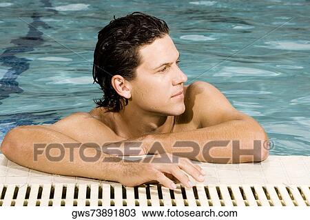 Close-up of a young man leaning at the edge of a swimming pool View Large Photo Image Stock Image - Close-up of a young man leaning at the edge of a swimming pool. Fotosearch