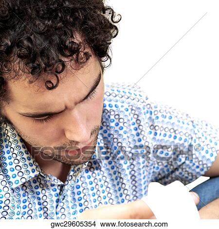 Close-up of a young man looking at a bill View Large Photo Image Picture - Close-up of a young man looking at a bill. Fotosearch